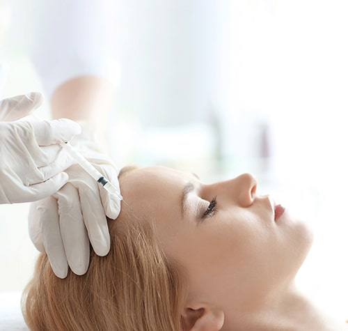 Young woman with hair problem receiving injection in clinic, clo
